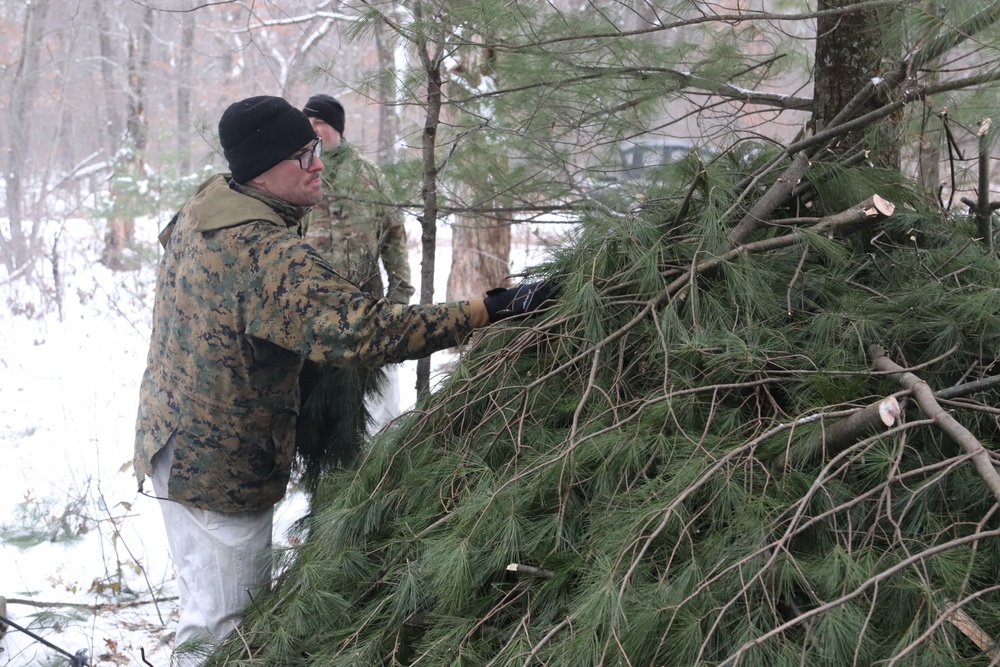 Cold-Weather Operations Course students build improvised shelters, survive outdoors