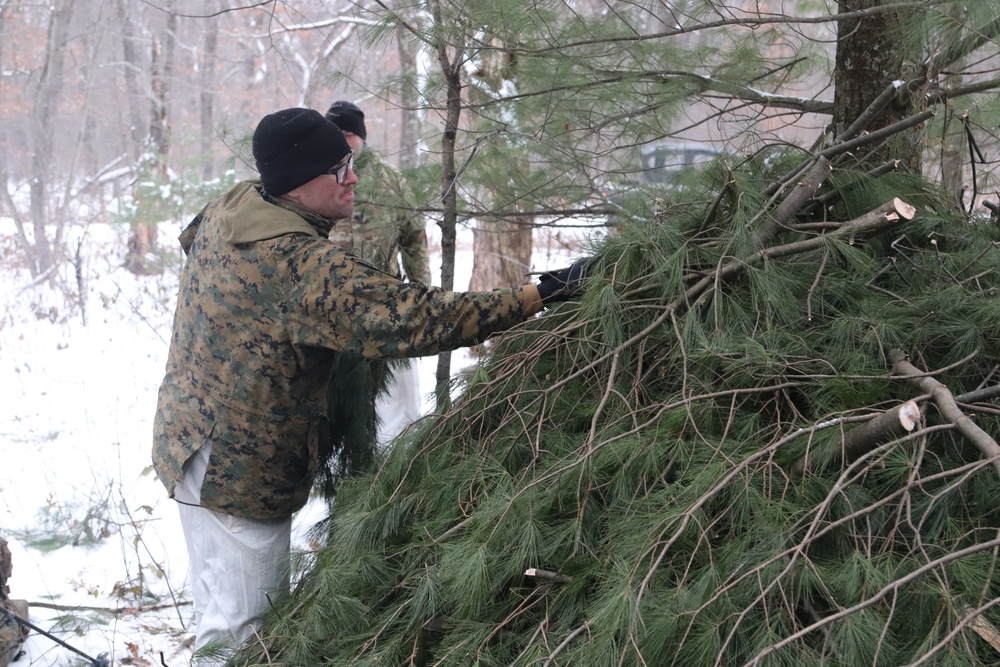 Cold-Weather Operations Course students build improvised shelters, survive outdoors