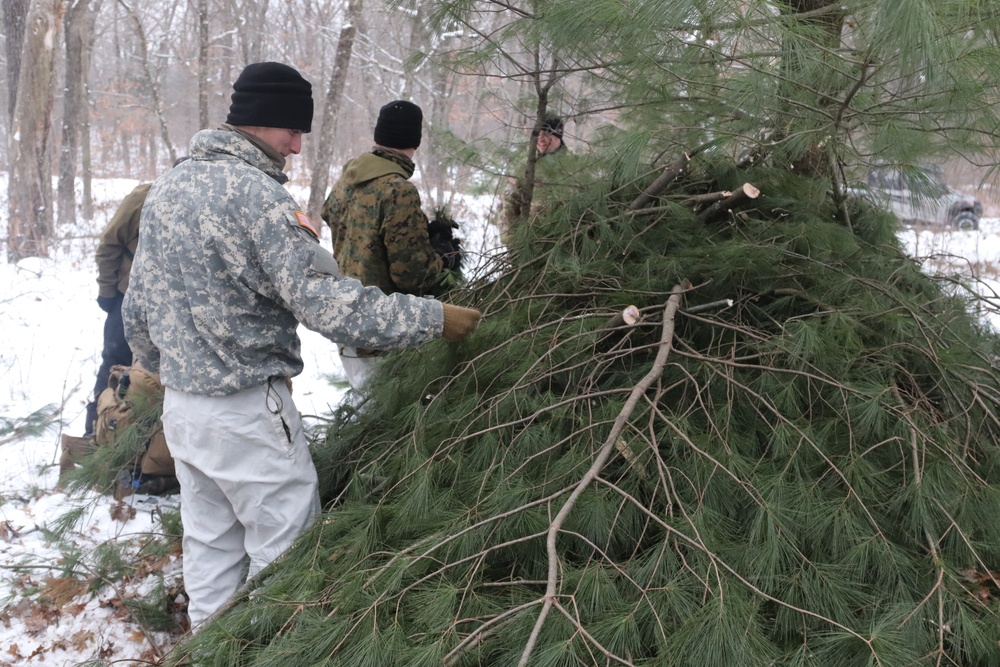 Cold-Weather Operations Course students build improvised shelters, survive outdoors