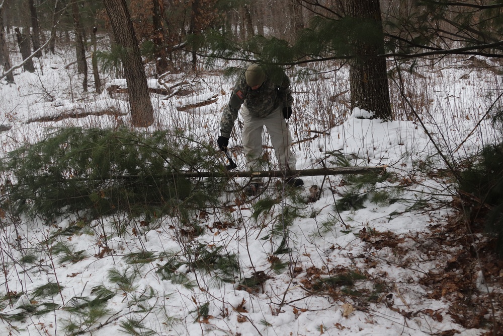 Cold-Weather Operations Course students build improvised shelters, survive outdoors