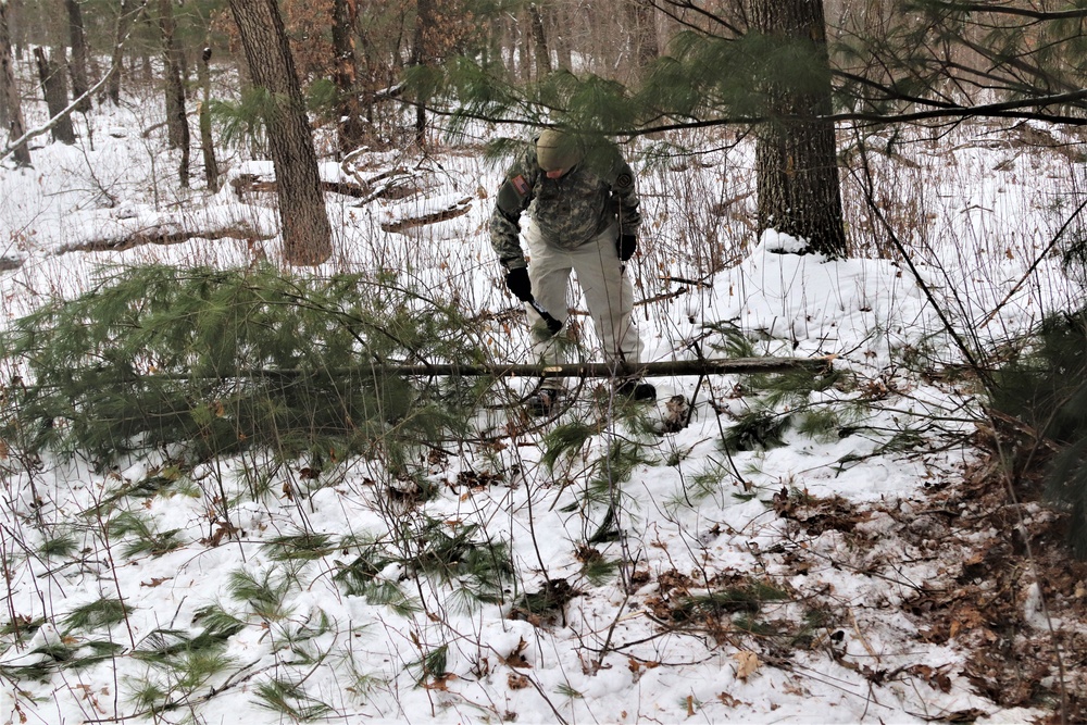 Cold-Weather Operations Course students build improvised shelters, survive outdoors