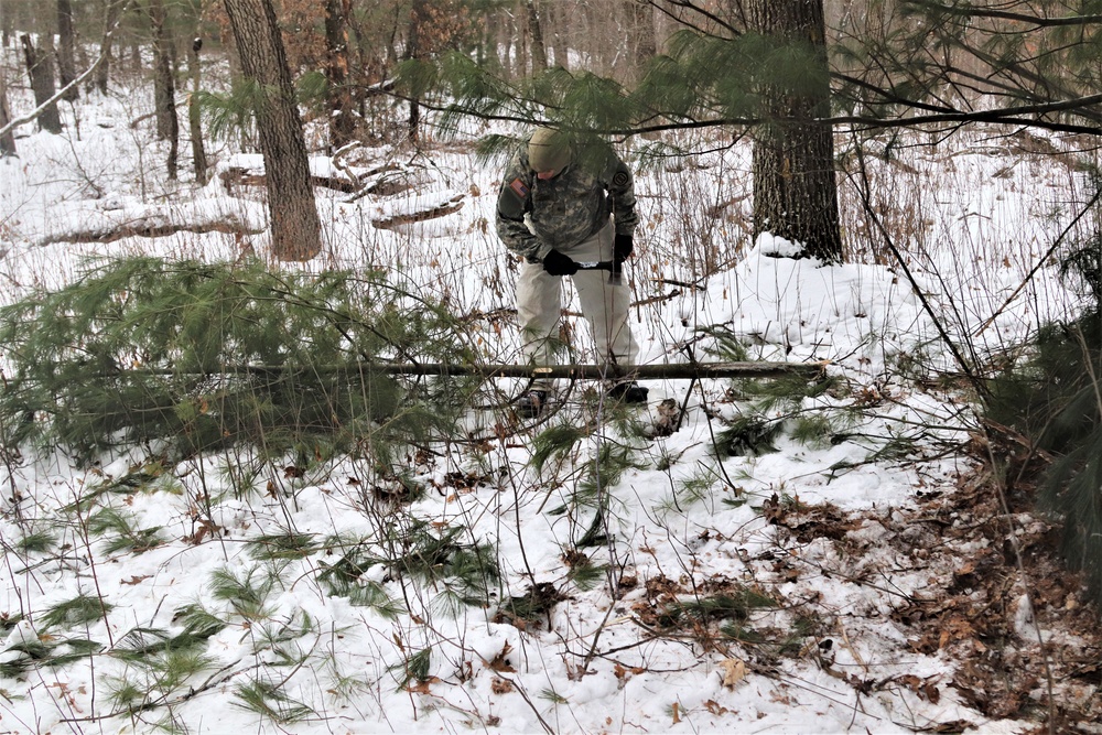 Cold-Weather Operations Course students build improvised shelters, survive outdoors