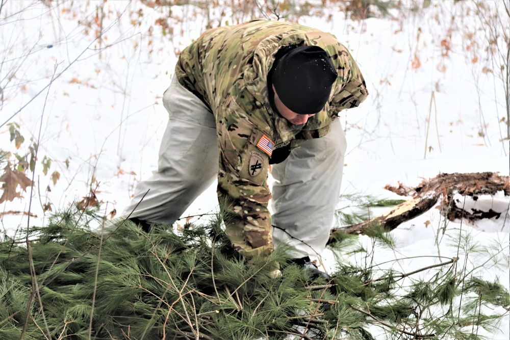 Improvised shelter building by Cold-Weather Operations Course students in Class 20-01