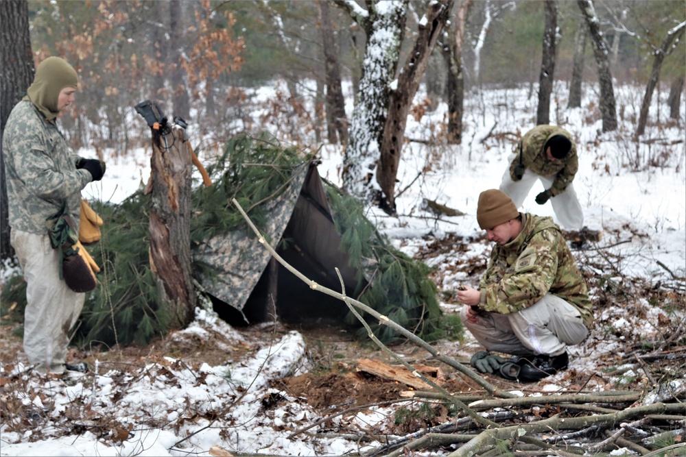 Improvised shelter building by Cold-Weather Operations Course students in Class 20-01