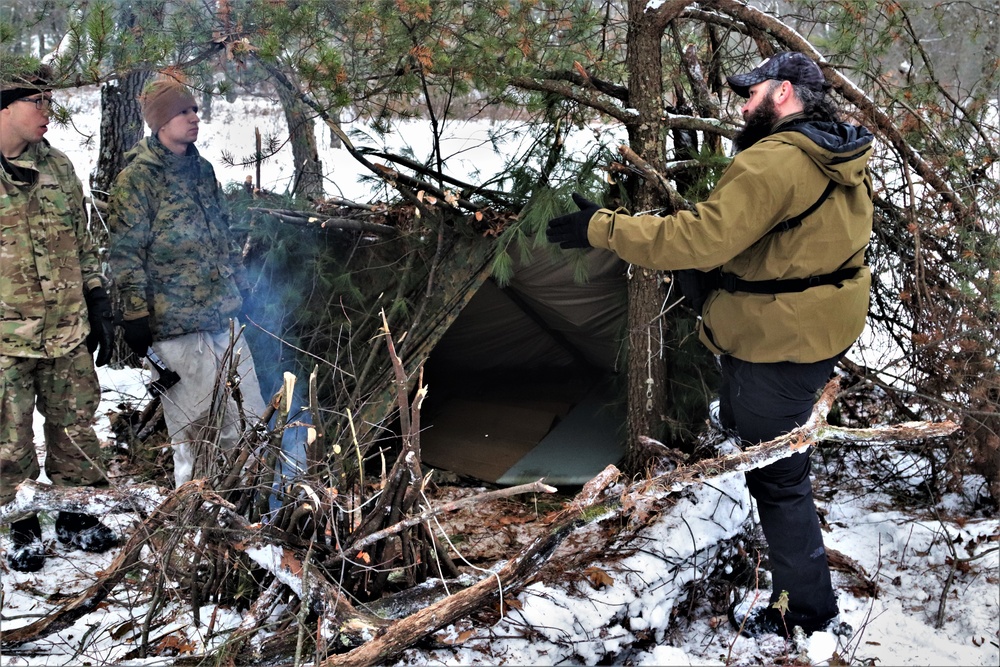 Improvised shelter building by Cold-Weather Operations Course students in Class 20-01