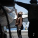 U.S. Sailor cleans an E-2C Hawkeye during flight operations