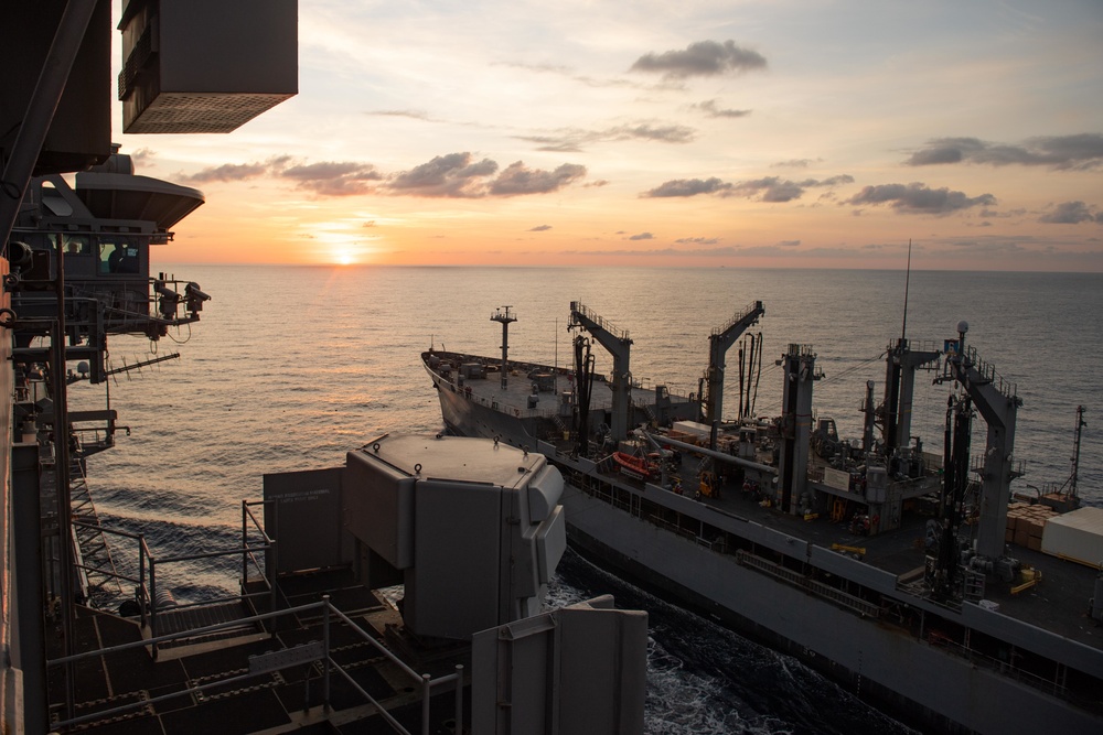 The fleet replenishment oiler USNS Walter S. Diehl (T-AO 193) sails alongside the aircraft carrier USS John C. Stennis (CVN 74)