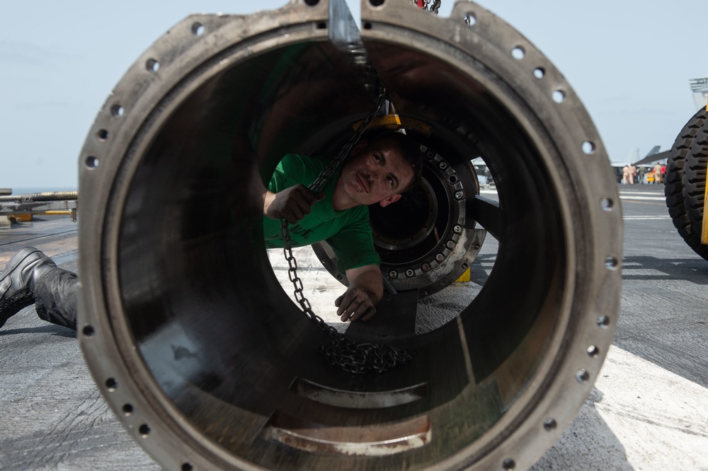 U.S. Sailor maintain a launching engine piston for a steam-powered catapult