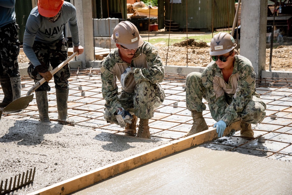 U.S. Navy Seabees deployed with NMCB-5’s Detail Palawan pour concrete at Malatgao Elementary School