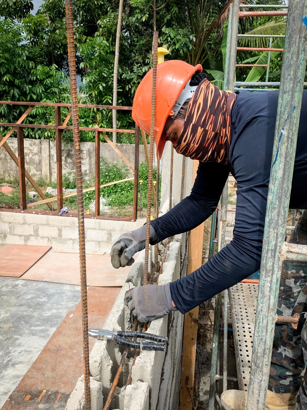 U.S. Navy Seabees deployed with NMCB-5’s Detail Palawan pour concrete at Malatgao Elementary School