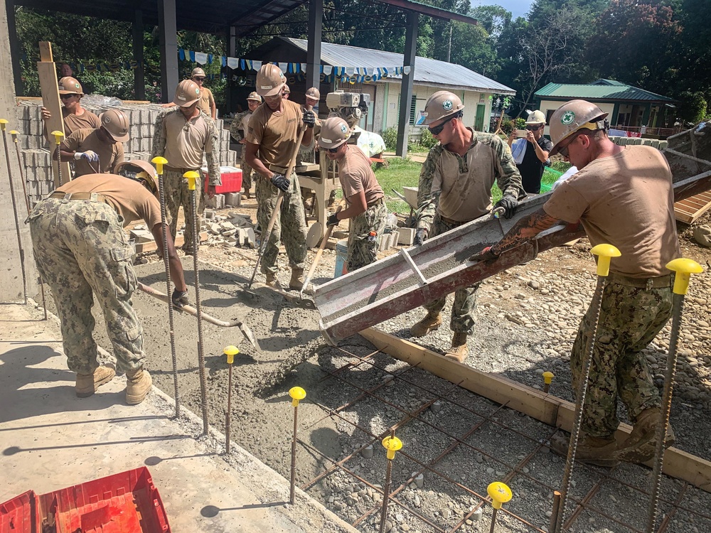 U.S. Navy Seabees deployed with NMCB-5’s Detail Palawan pour concrete at Malatgao Elementary School