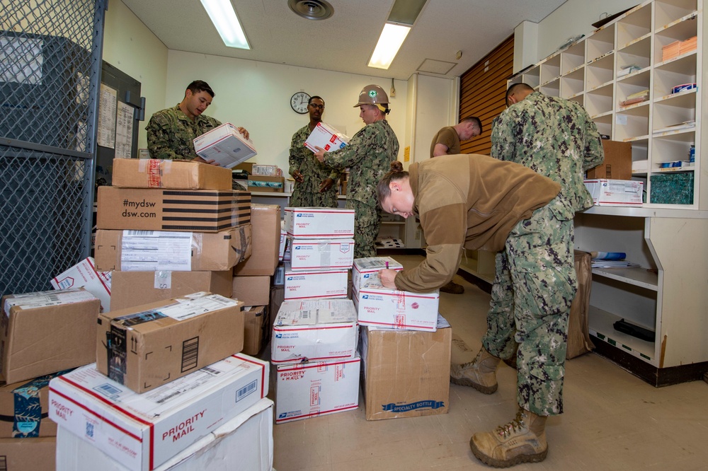 U.S. Navy Seabees deployed with NMCB-5 receive mail during the holidays