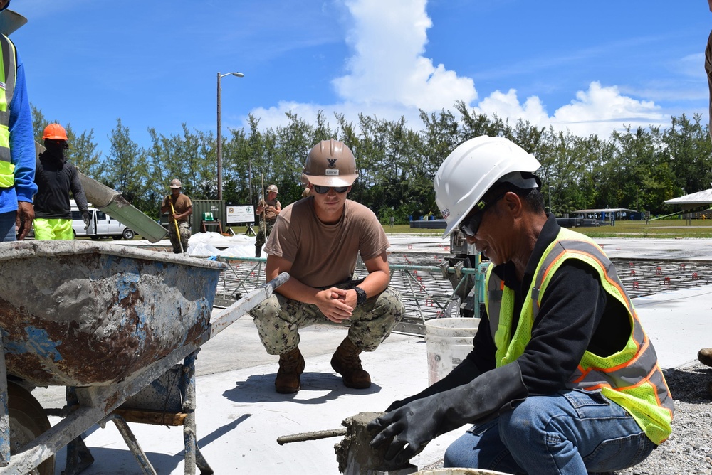 U.S. Navy Seabees from NMCB 5’s Detail Diego Garcia place concrete in support of the U.S. Air Force