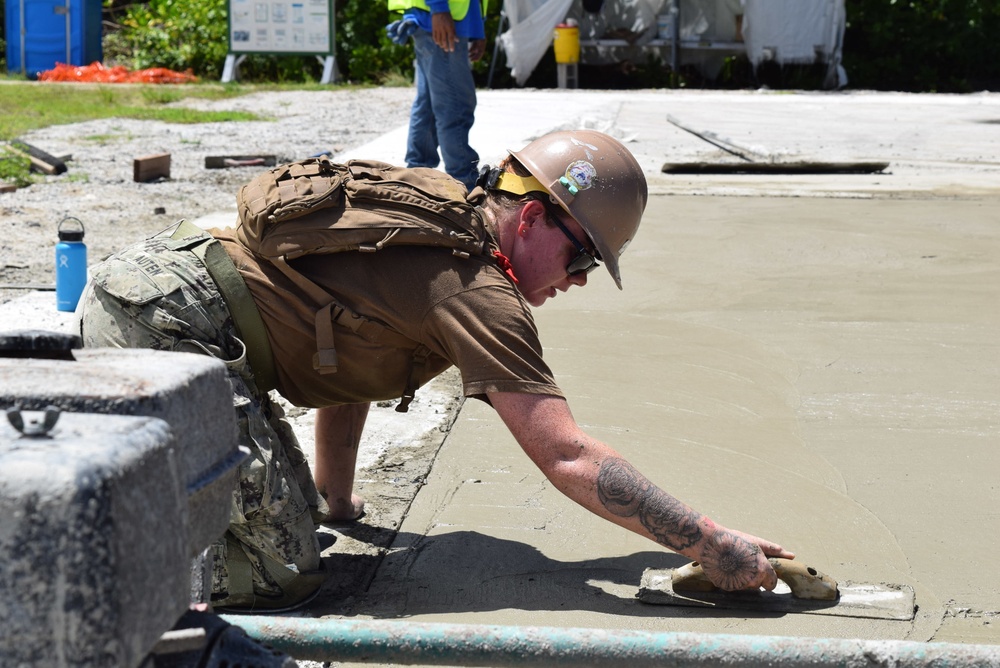 U.S. Navy Seabees from NMCB 5’s Detail Diego Garcia place concrete in support of the U.S. Air Force