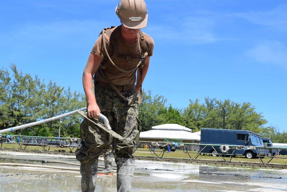 U.S. Navy Seabees from NMCB 5’s Detail Diego Garcia place concrete in support of the U.S. Air Force