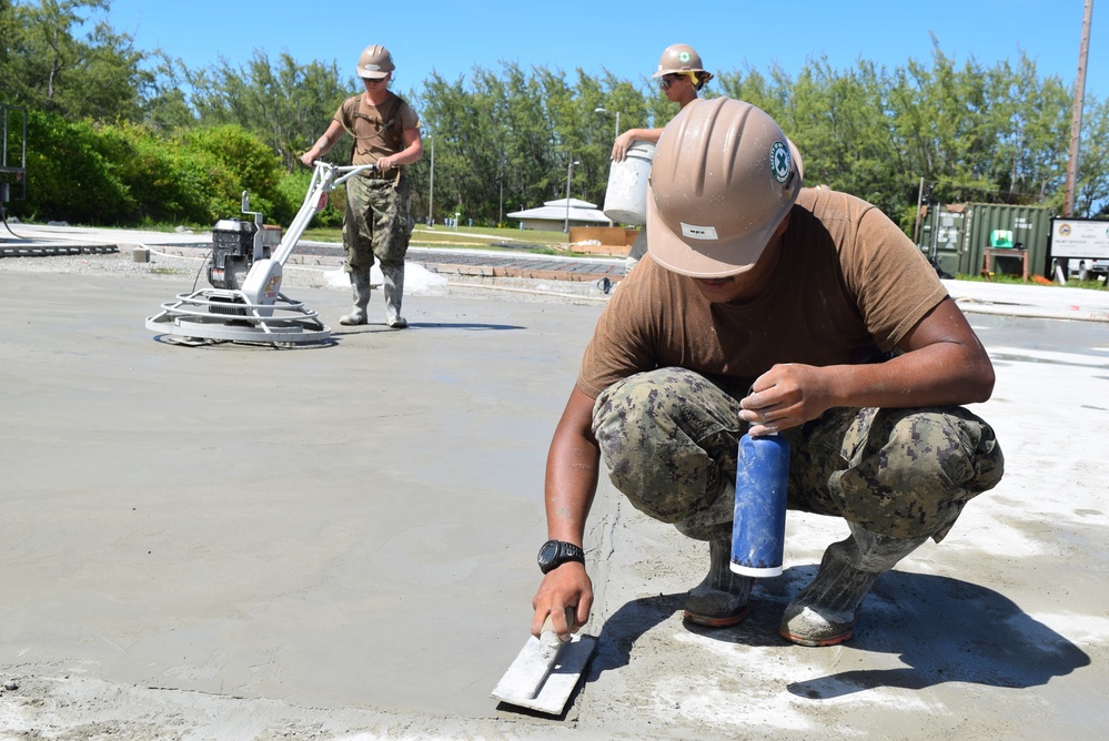 U.S. Navy Seabees from NMCB 5’s Detail Diego Garcia place concrete in support of the U.S. Air Force