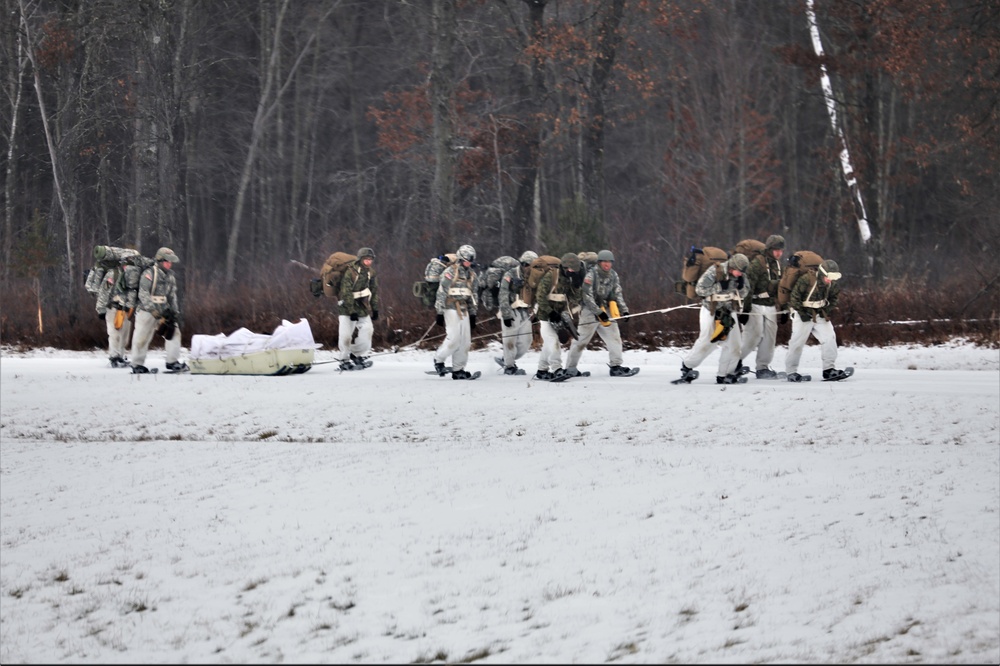 Fort McCoy Cold-Weather Operations Course students train in snowshoes pulling ahkio sled