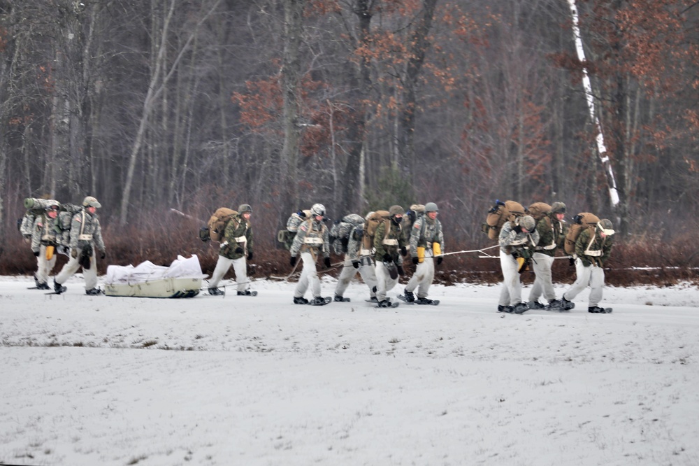 Fort McCoy Cold-Weather Operations Course students train in snowshoes pulling ahkio sled