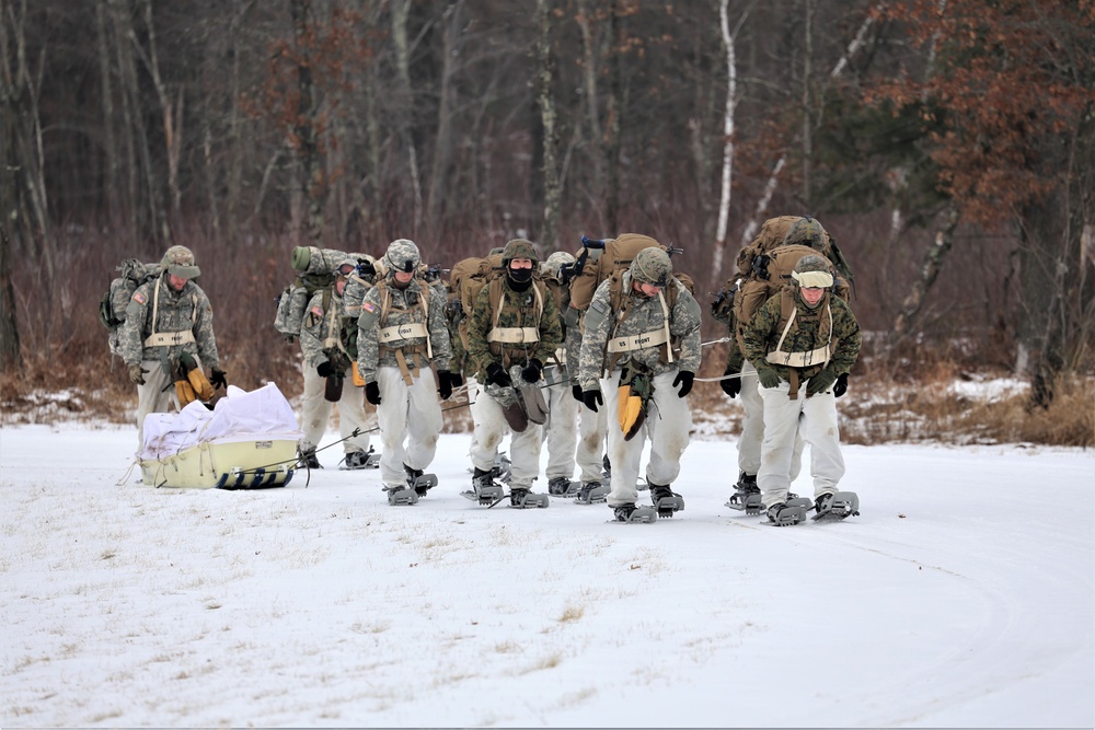 Fort McCoy Cold-Weather Operations Course students train in snowshoes pulling ahkio sled