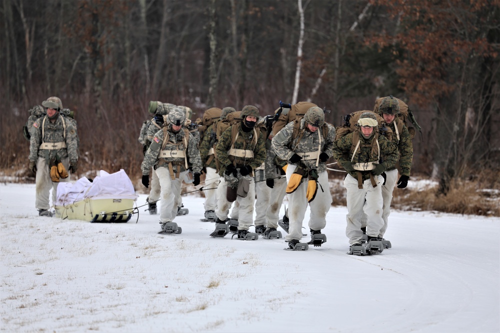 Fort McCoy Cold-Weather Operations Course students train in snowshoes pulling ahkio sled