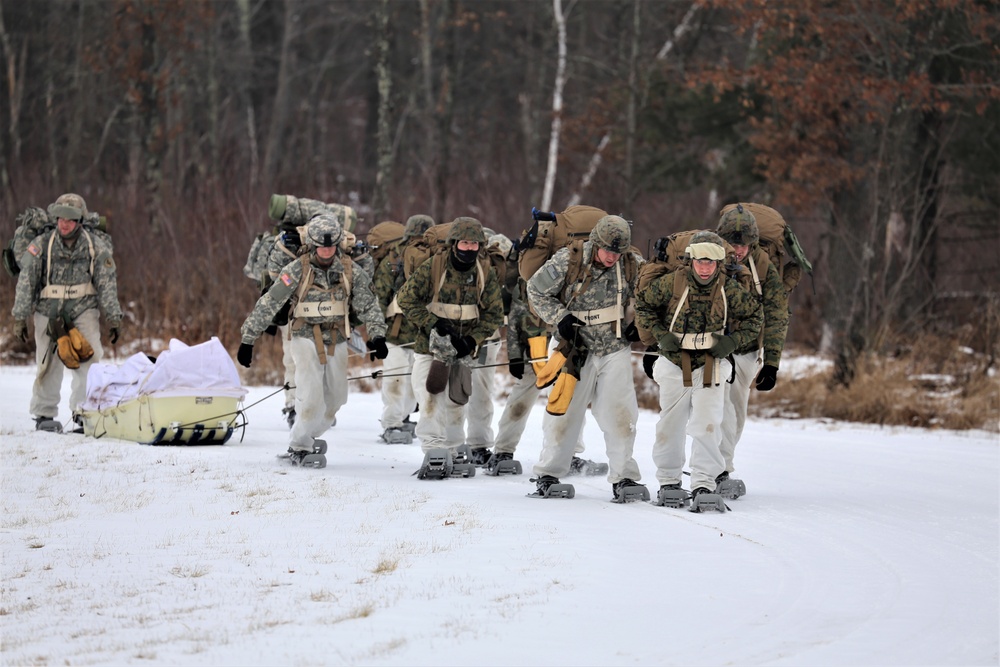 Fort McCoy Cold-Weather Operations Course students train in snowshoes pulling ahkio sled