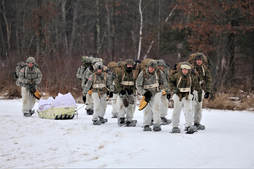 Fort McCoy Cold-Weather Operations Course students train in snowshoes pulling ahkio sled