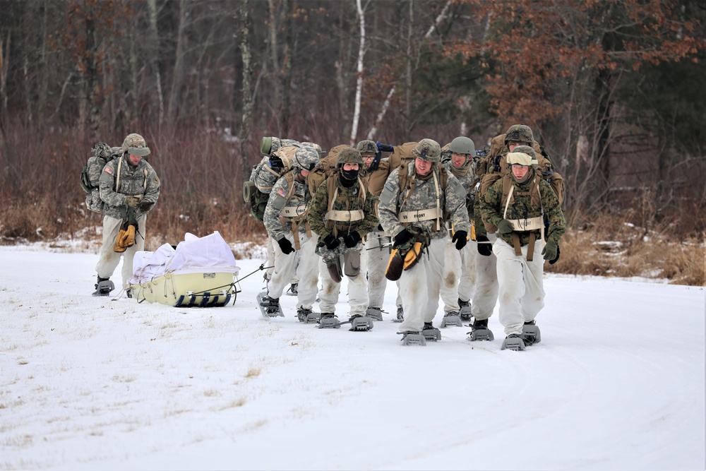 Fort McCoy Cold-Weather Operations Course students train in snowshoes pulling ahkio sled