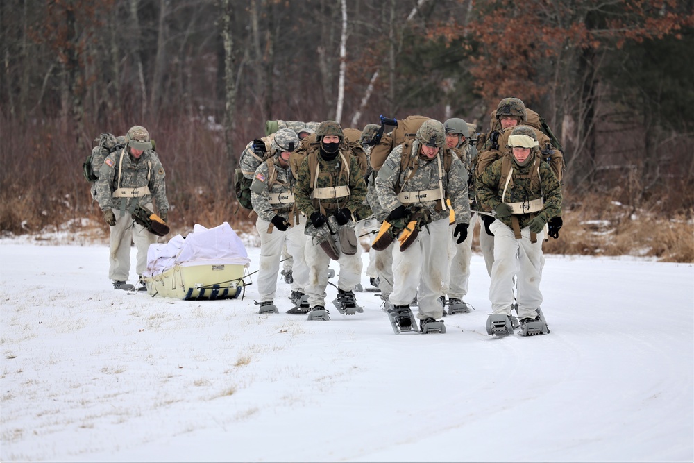 Fort McCoy Cold-Weather Operations Course students train in snowshoes pulling ahkio sled