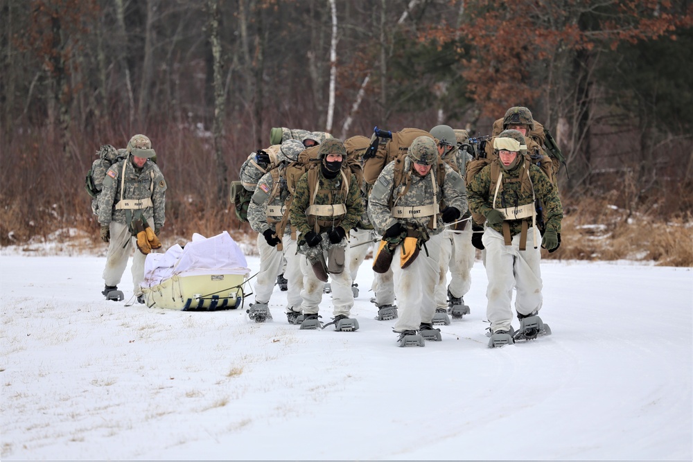 Fort McCoy Cold-Weather Operations Course students train in snowshoes pulling ahkio sled