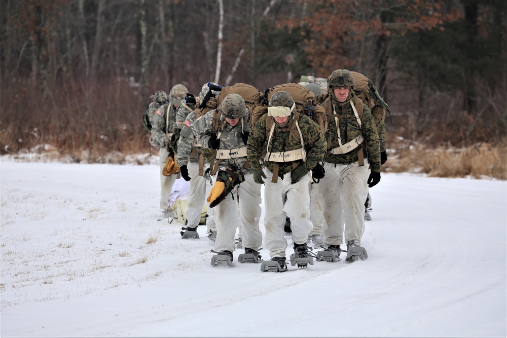 Fort McCoy Cold-Weather Operations Course students train in snowshoes pulling ahkio sled