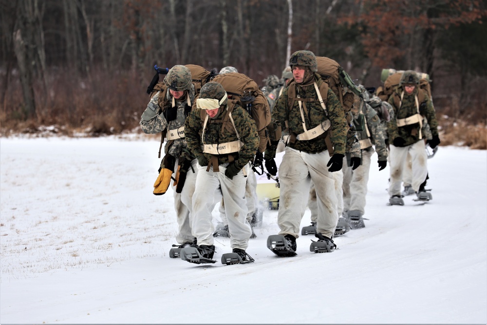 Fort McCoy Cold-Weather Operations Course students train in snowshoes pulling ahkio sled