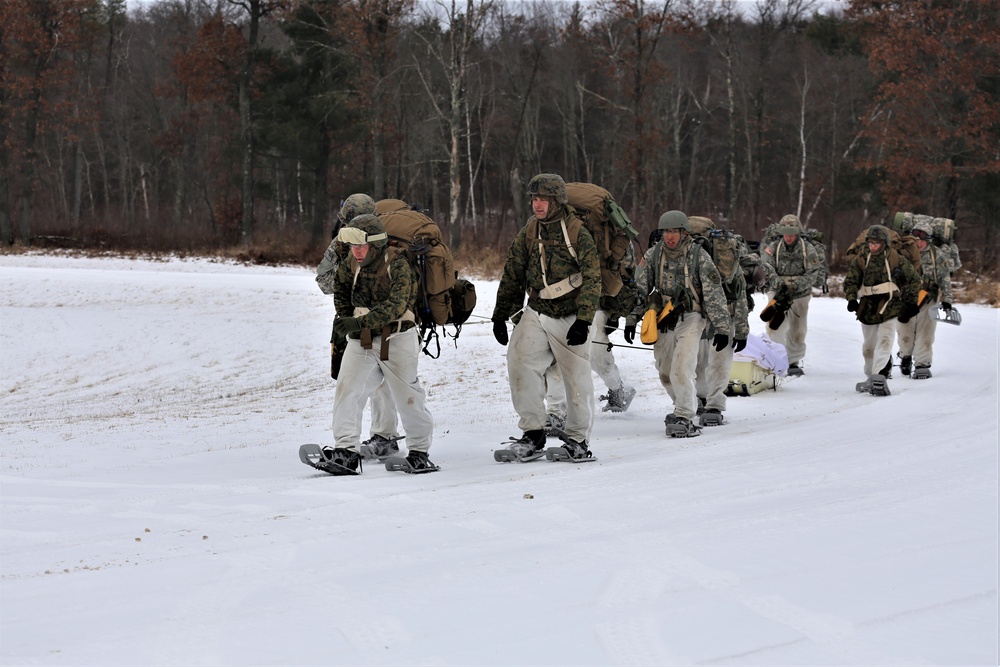 Fort McCoy Cold-Weather Operations Course students train in snowshoes pulling ahkio sled