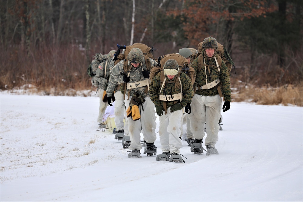 Fort McCoy Cold-Weather Operations Course students train in snowshoes pulling ahkio sled