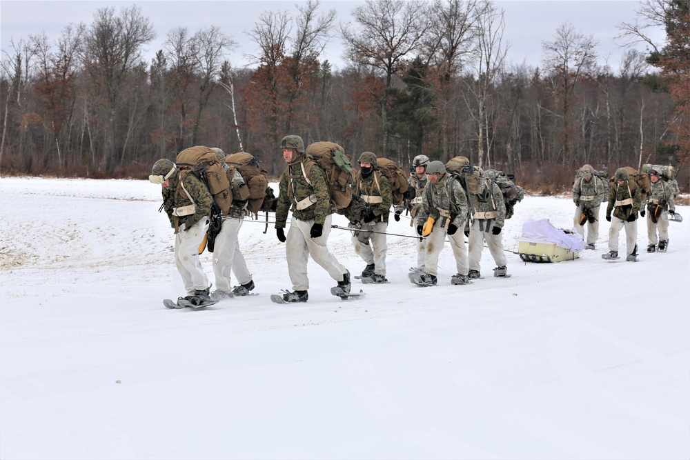 Fort McCoy Cold-Weather Operations Course students train in snowshoes pulling ahkio sled