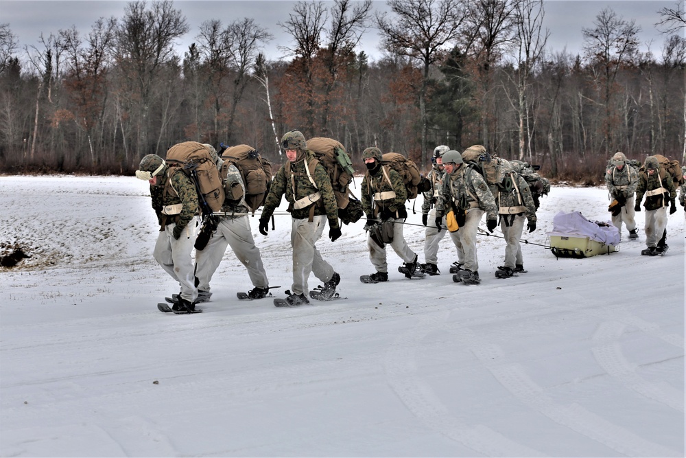 Fort McCoy Cold-Weather Operations Course students train in snowshoes pulling ahkio sled