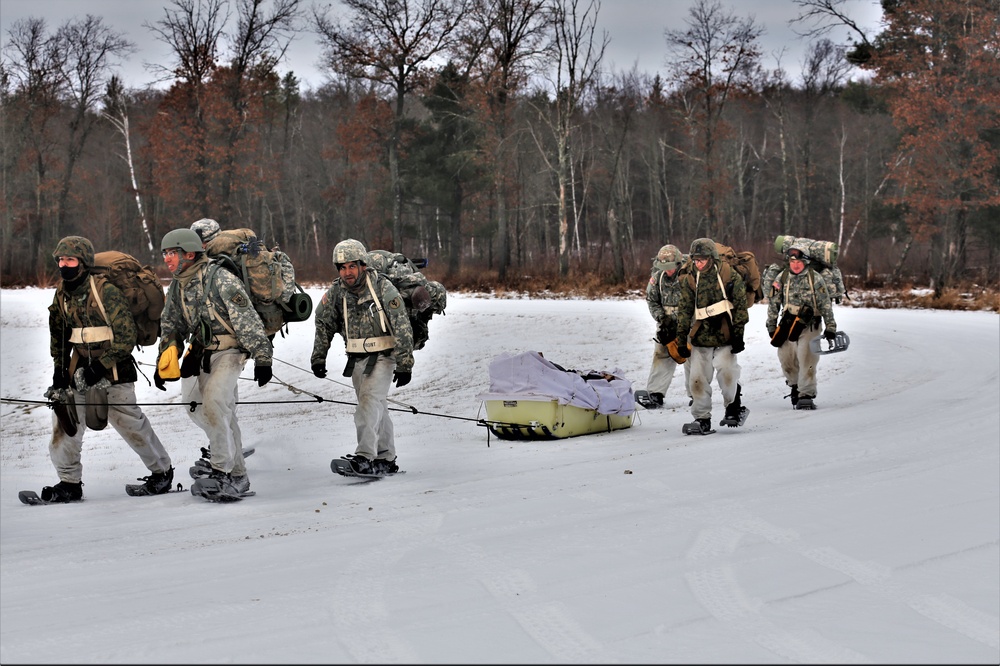 Fort McCoy Cold-Weather Operations Course students train in snowshoes pulling ahkio sled