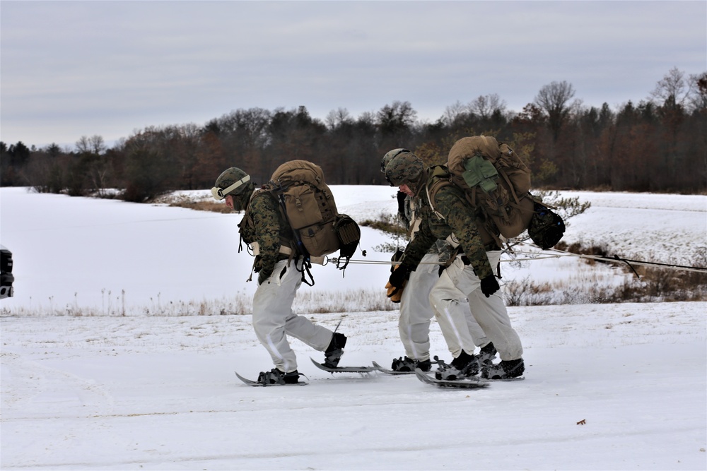 Fort McCoy Cold-Weather Operations Course students train in snowshoes pulling ahkio sled