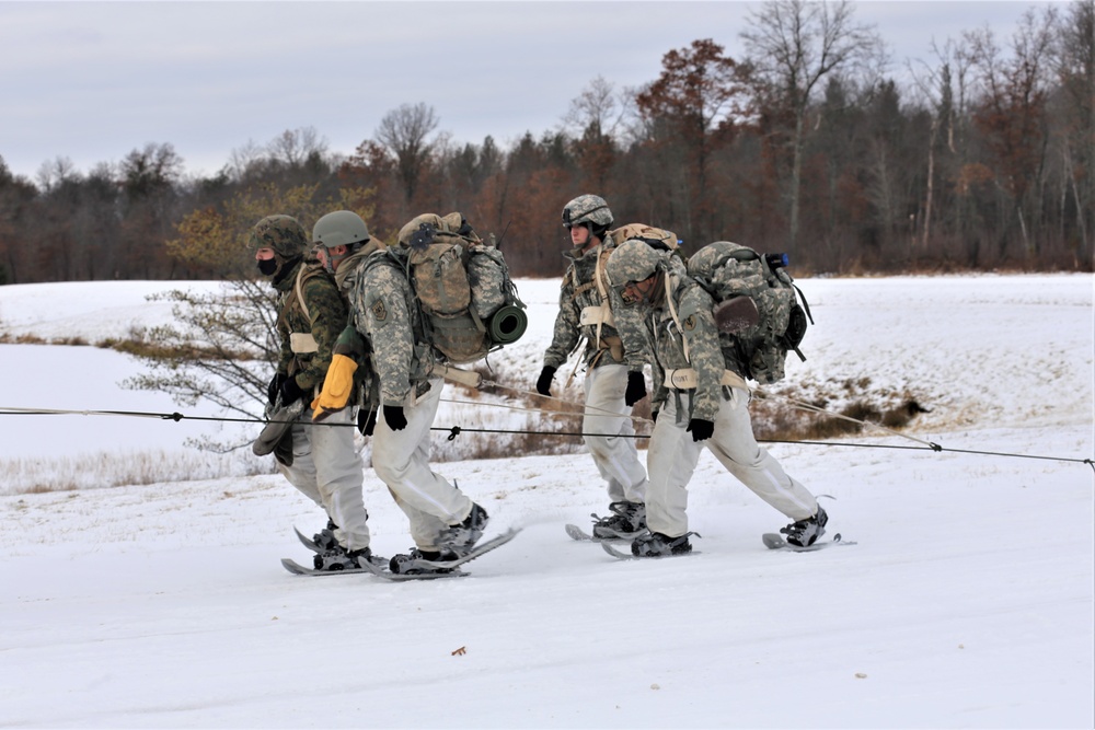 Fort McCoy Cold-Weather Operations Course students train in snowshoes pulling ahkio sled