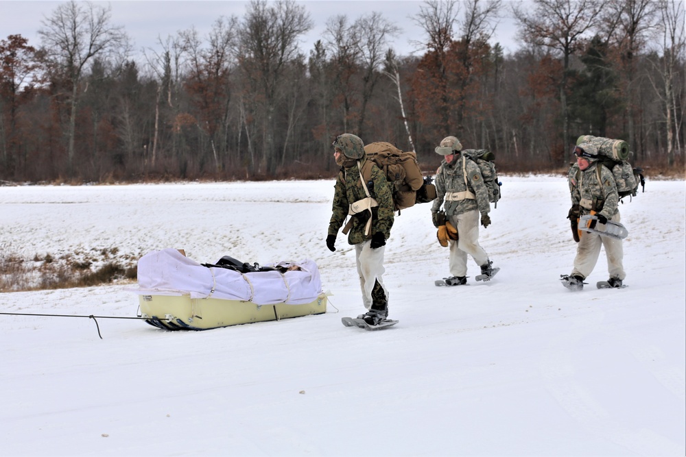 Fort McCoy Cold-Weather Operations Course students train in snowshoes pulling ahkio sled