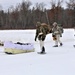 Fort McCoy Cold-Weather Operations Course students train in snowshoes pulling ahkio sled