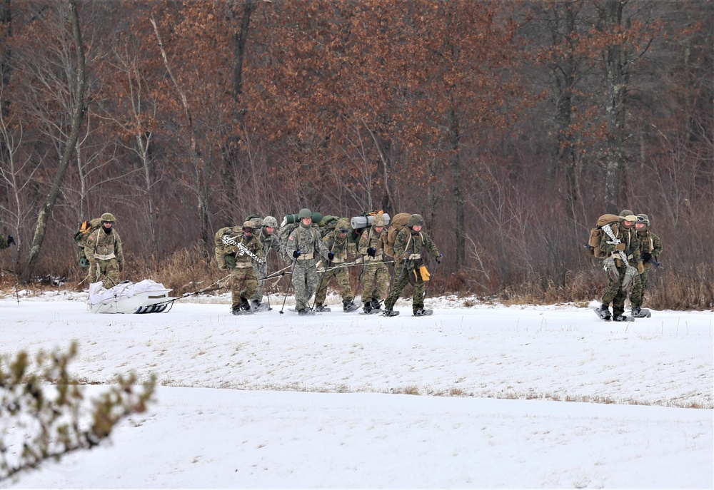 Fort McCoy Cold-Weather Operations Course students train in snowshoes pulling ahkio sled