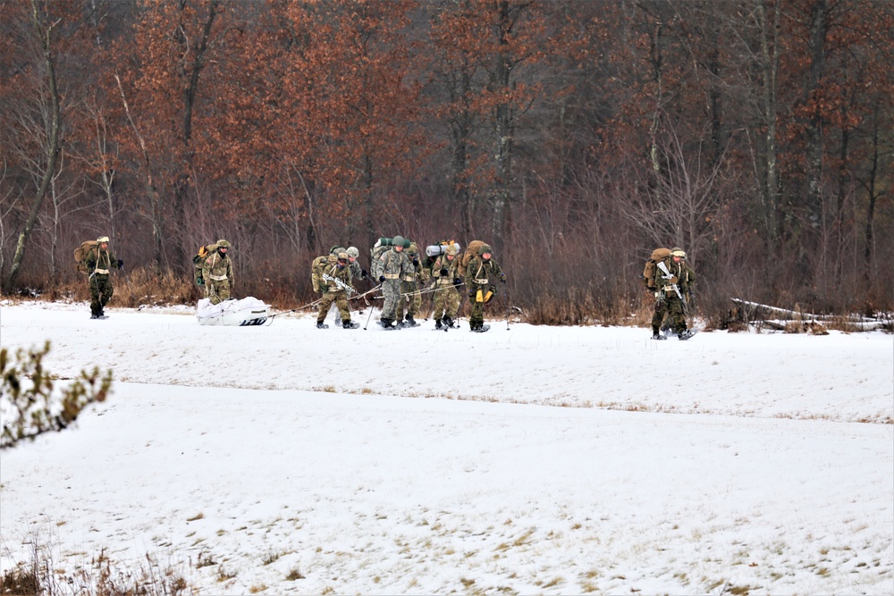 Fort McCoy Cold-Weather Operations Course students train in snowshoes pulling ahkio sled