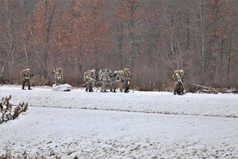 Fort McCoy Cold-Weather Operations Course students train in snowshoes pulling ahkio sled