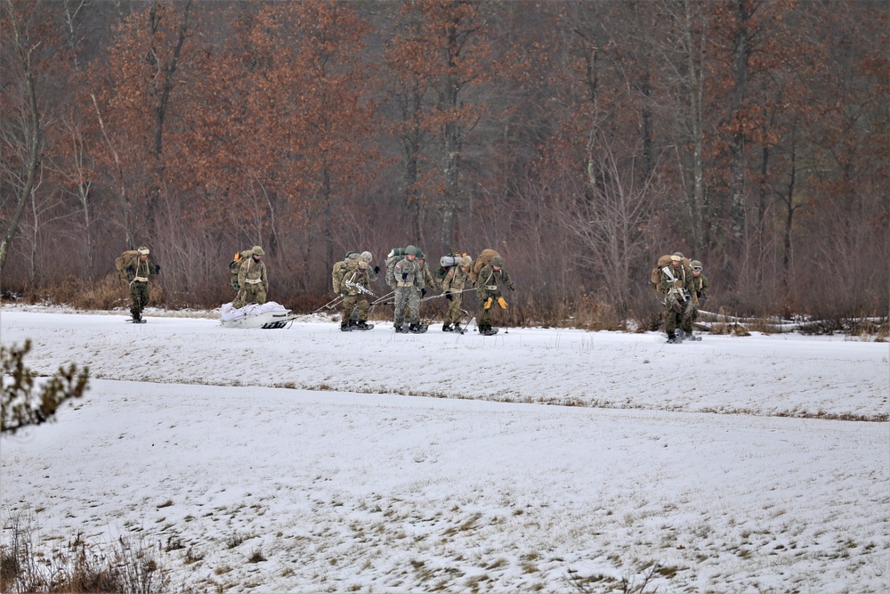 Fort McCoy Cold-Weather Operations Course students train in snowshoes pulling ahkio sled