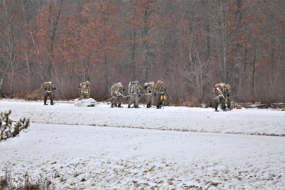 Fort McCoy Cold-Weather Operations Course students train in snowshoes pulling ahkio sled