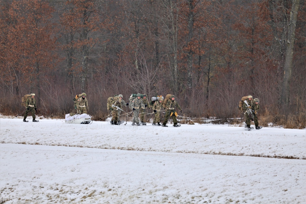 Fort McCoy Cold-Weather Operations Course students train in snowshoes pulling ahkio sled