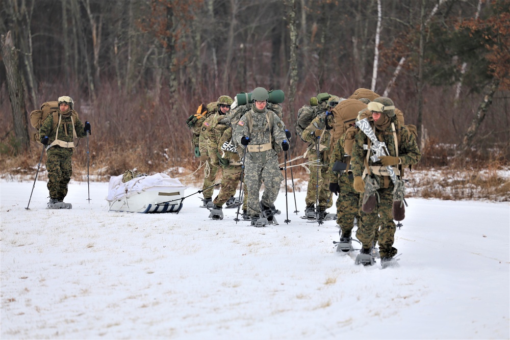 Fort McCoy Cold-Weather Operations Course students train in snowshoes pulling ahkio sled