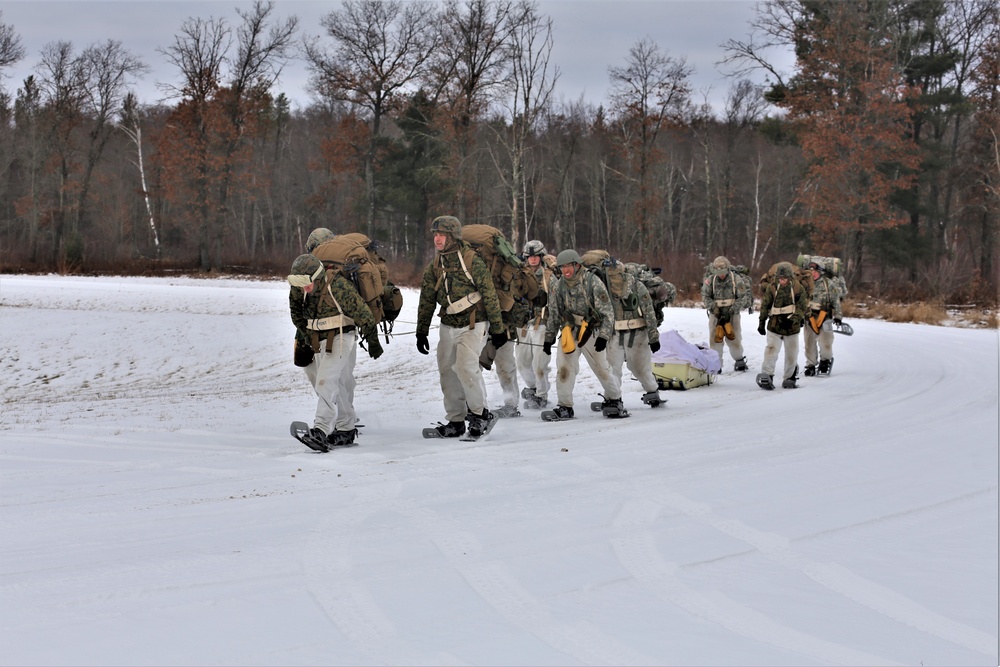 Fort McCoy Cold-Weather Operations Course students train in snowshoes pulling ahkio sled