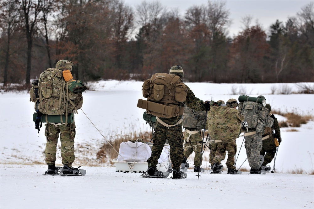 Fort McCoy Cold-Weather Operations Course students train in snowshoes pulling ahkio sled