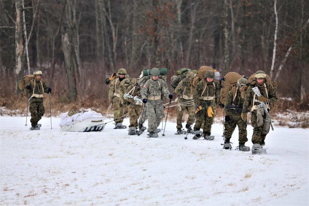 Fort McCoy Cold-Weather Operations Course students train in snowshoes pulling ahkio sled